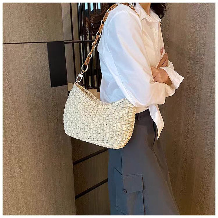 Handcrafted straw bag with golden chain details Stornfield