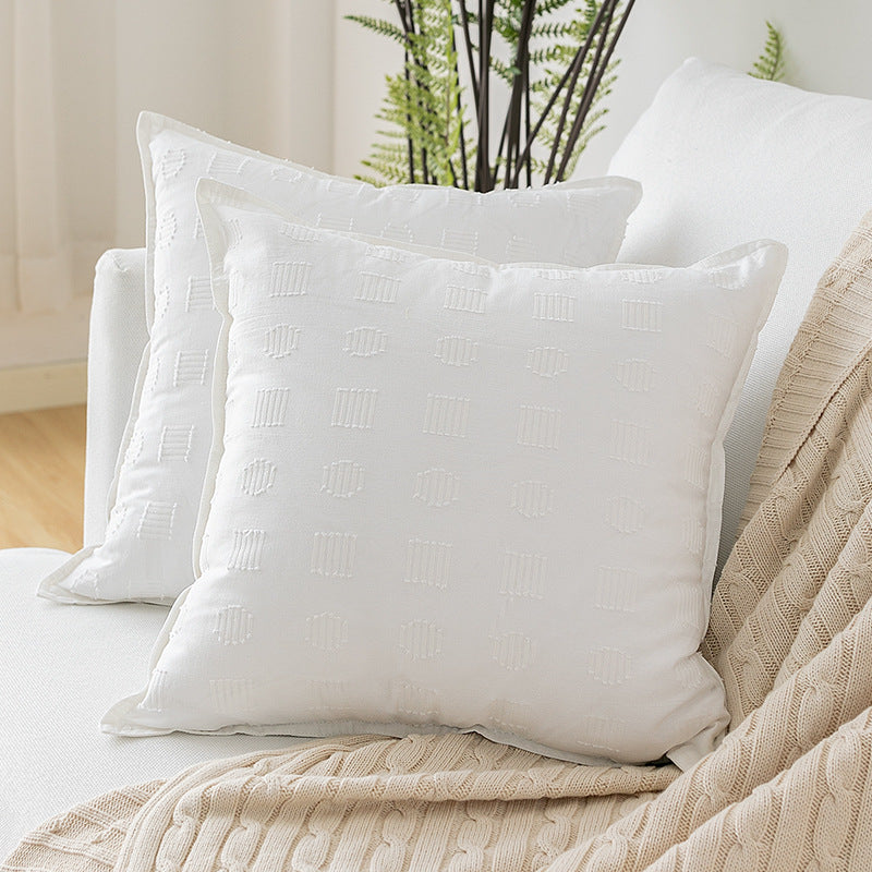 Square decorative cushion cover with subtle tufted geometric relief and piping
