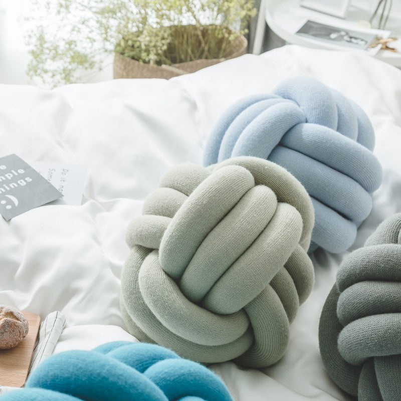 Decorative knitted knot cushion as a decorative pillow made of soft jersey