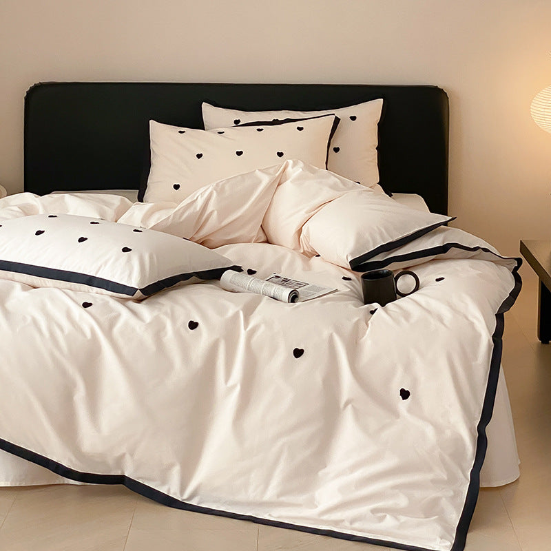 High-quality cotton satin bedding set with delicate embroidery, reversible feature & piping edge