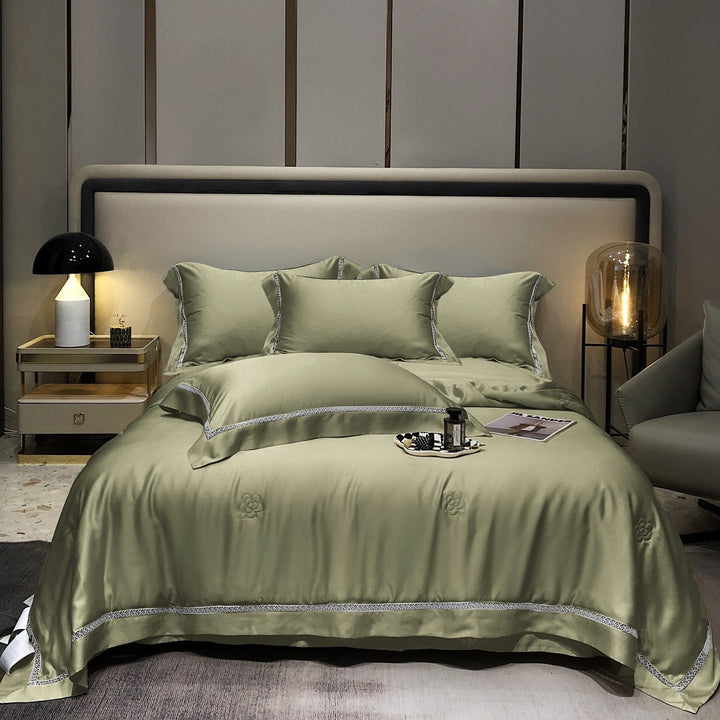 Luxurious satin bedding set with fine embroidered border and tone-on-tone floral relief