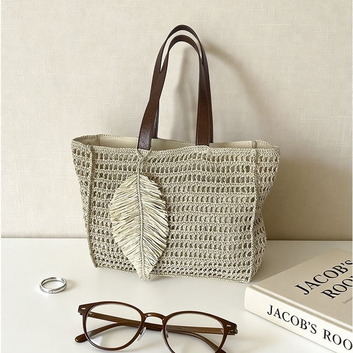 Handbag made of hand-woven natural material with decorative leaf shape design Stornfield