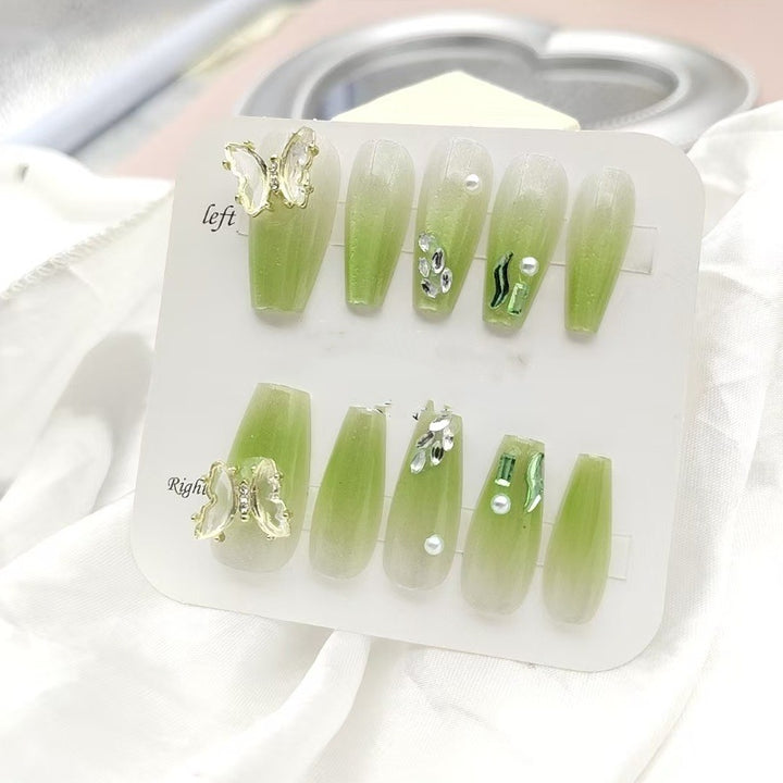 Artificial nails with butterfly accents and glitter details Stornfield