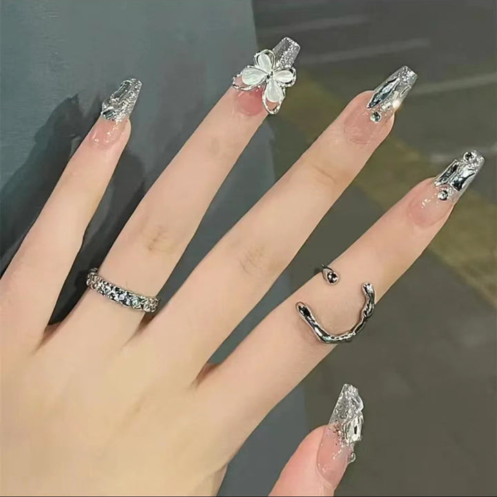 Artful Nail Art with Glitter and Butterfly Elements Stornfield