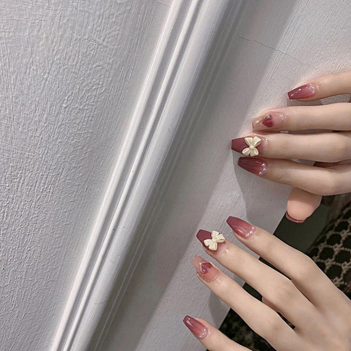 Artificial nails with heart accent and glamorous decorations Stornfield