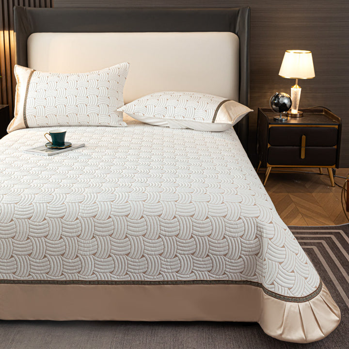 Quilted bedspread set with satin ruffle and geometric wave relief
