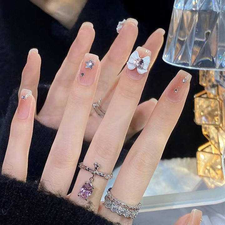 Artistic nail tips with floral and glittering accents Stornfield