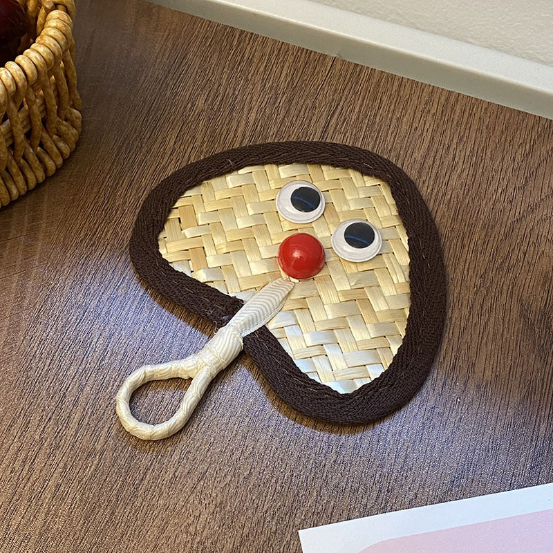 Handcrafted fan with playful face motif Stornfield