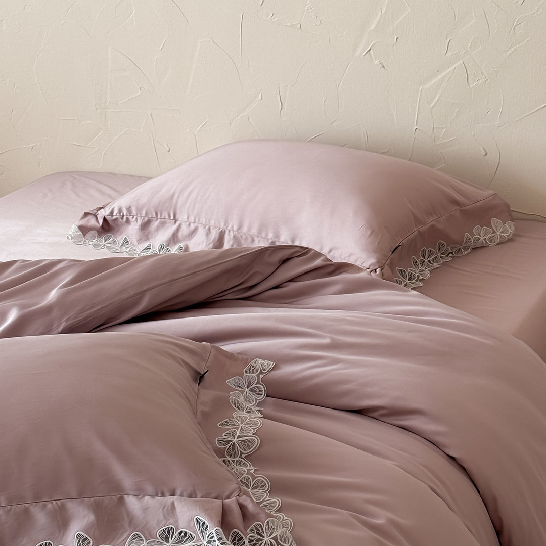 Satin bedding set with silky-smooth texture and floral lace trim