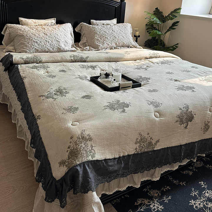 Quilted bedspread with lace trim and vintage stripe pattern