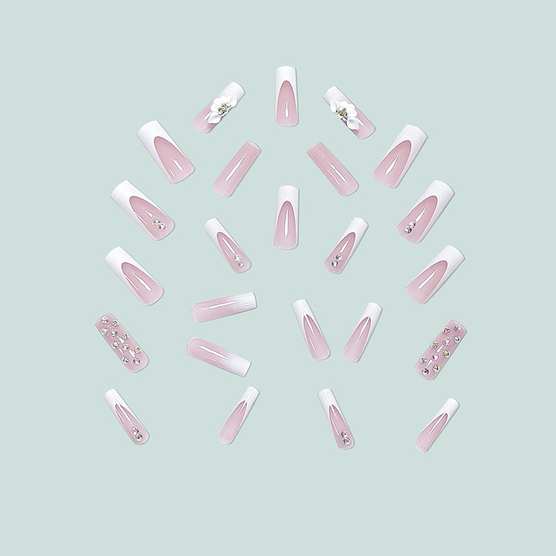 Artful stiletto nails with floral accents and rhinestone details Stornfield