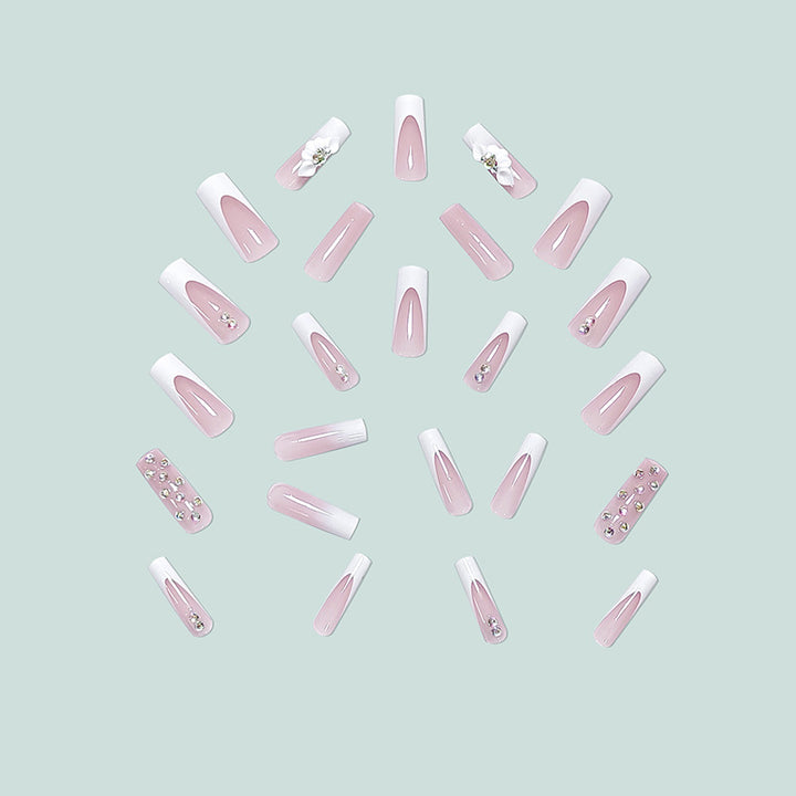 Artful stiletto nails with floral accents and rhinestone details Stornfield