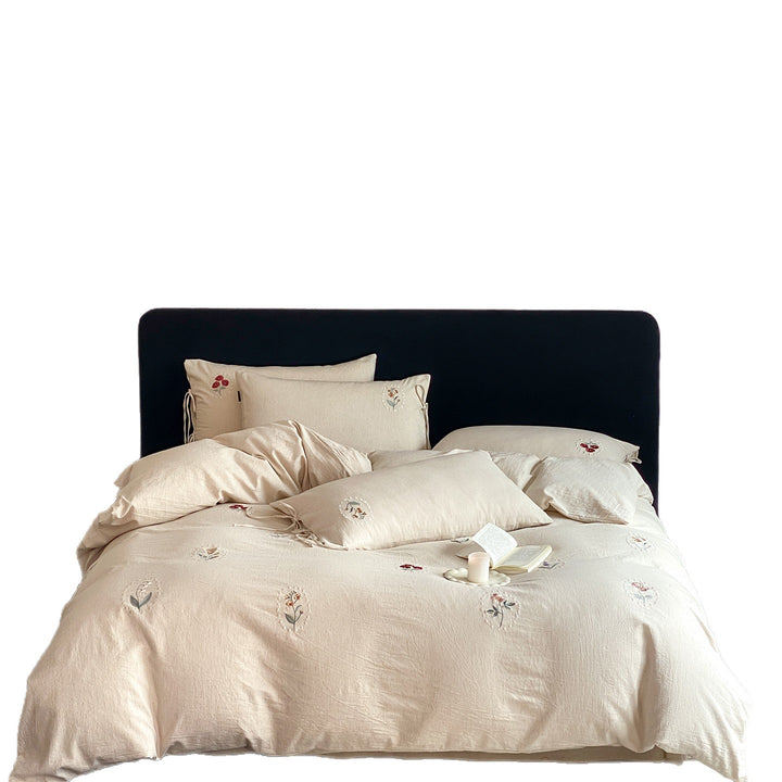 Embroidered linen bedding set with subtle floral patterns