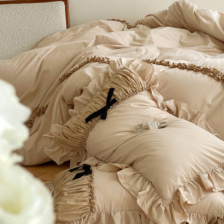 Luxurious satin bedding set with gathered ruffle, braided decorative ribbons and bow appliqué