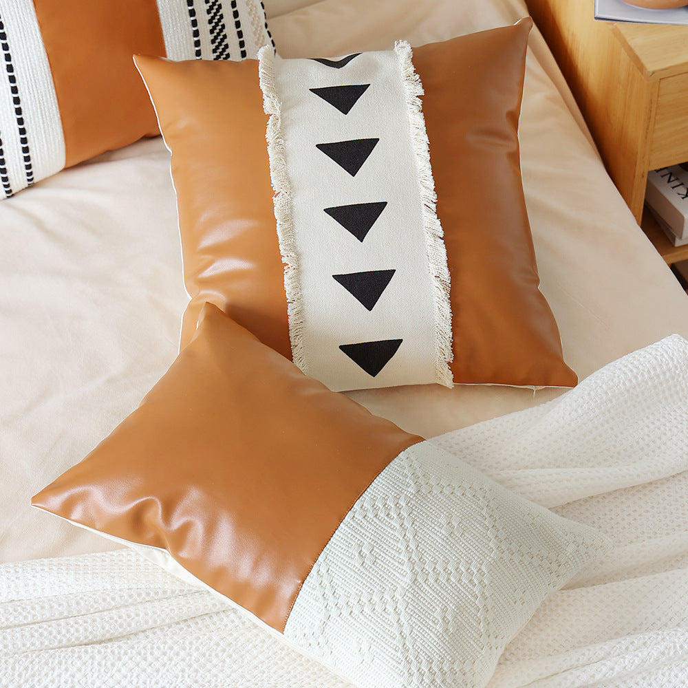 Square faux leather decorative cushion with woven central stripe and fringes