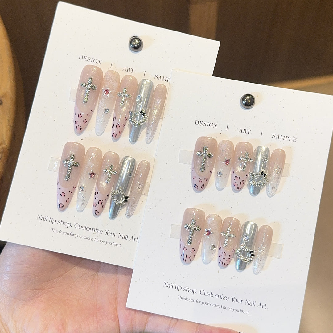 Artificial nails with sparkling rhinestones and cross motifs Stornfield