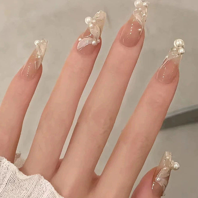 Elegant nail design with pearl embellishment Stornfield