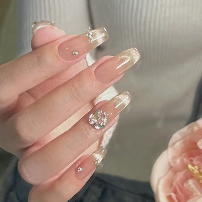 Acrylic nail set with glamorous glitter accents and elegant jewelry embellishments Stornfield
