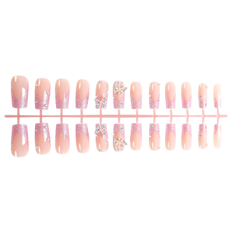 Acrylic nail set with sparkling glitter accents and elegant butterfly motifs Stornfield