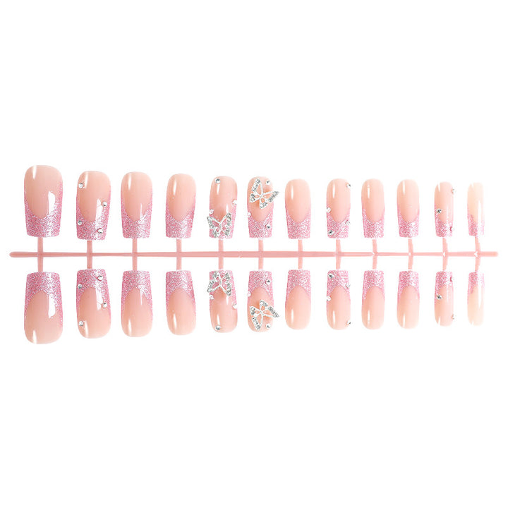 Acrylic nail set with sparkling glitter accents and elegant butterfly motifs Stornfield