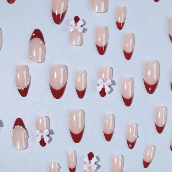 Artificial nail set with glamorous rhinestone and bow decorations Stornfield