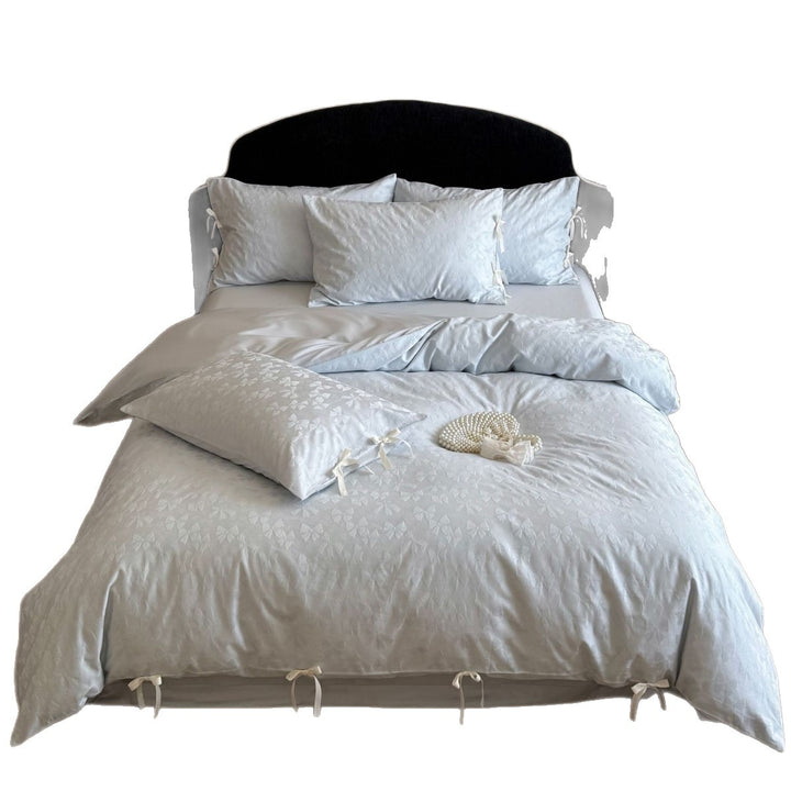 Luxurious cotton satin bed set with delicate ribbon ties and jacquard relief