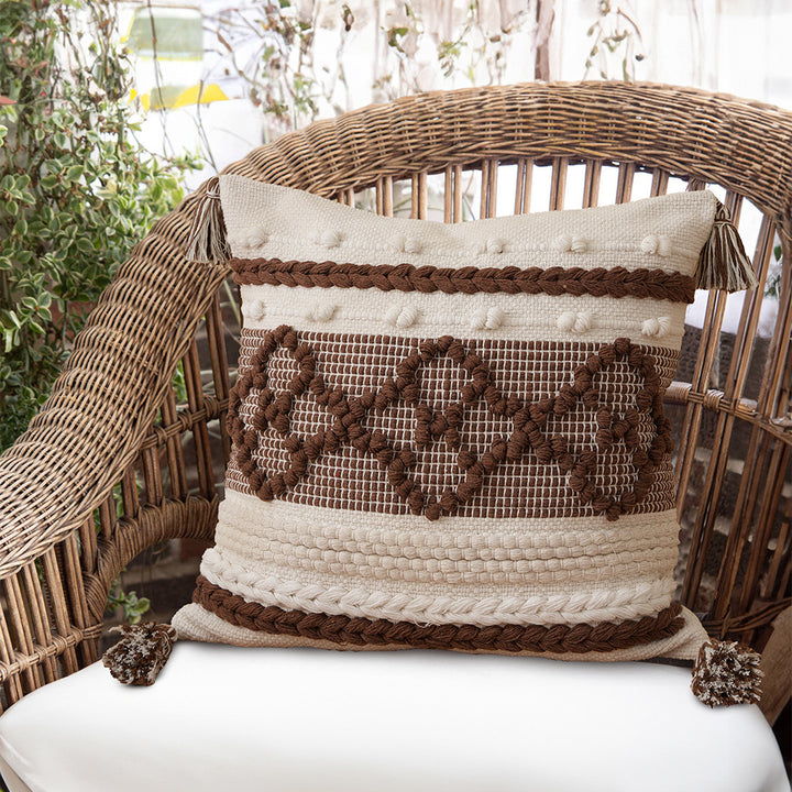 Structured decorative pillow with tufted diamonds, relief border, and corner tassels