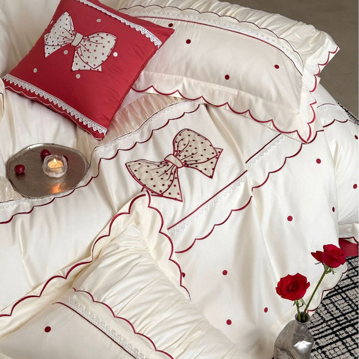 Elegant cotton satin bedding set with decorative bow appliqué and gathered frill