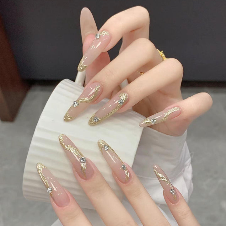 Artificial nail set with elegant gold design and sparkling applications Stornfield