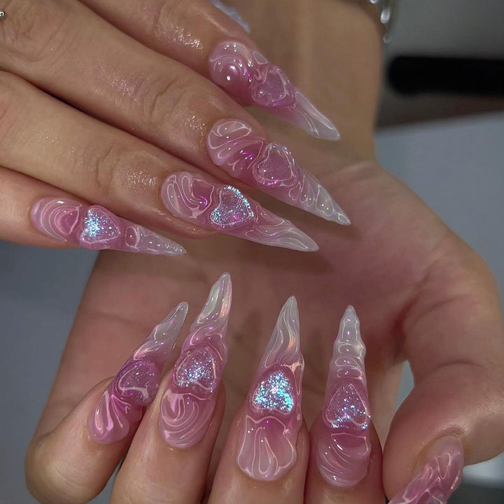 Artistic stiletto nails with heart design and glitter accents Stornfield