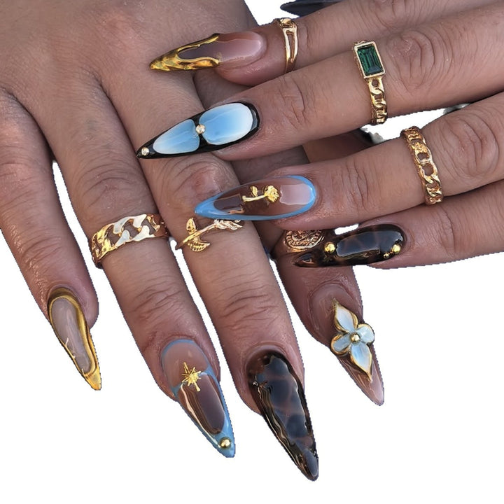Artificial nail set with luxurious gold design and floral accents Stornfield