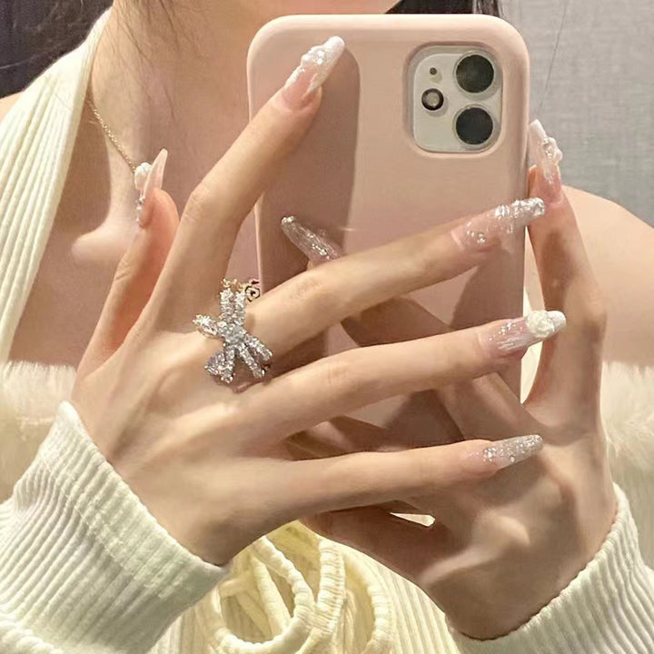 Elegant artificial nails with glitter and flower decoration Stornfield