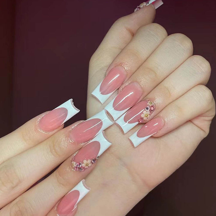 Artificial nail set with elegant floral decorations and transparent finish Stornfield