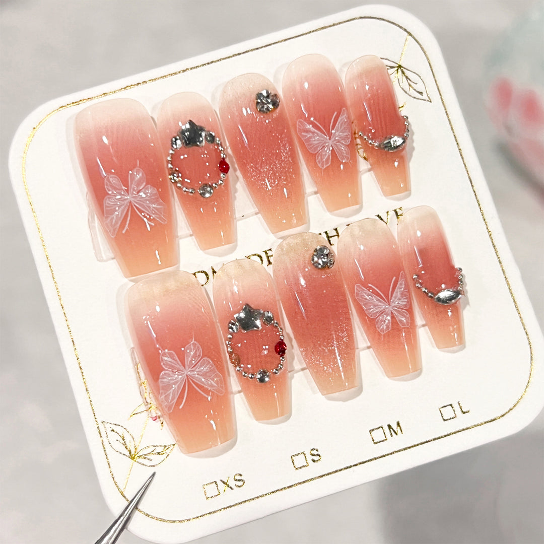 Artificial nail extensions with floral design and sparkling accents Stornfield