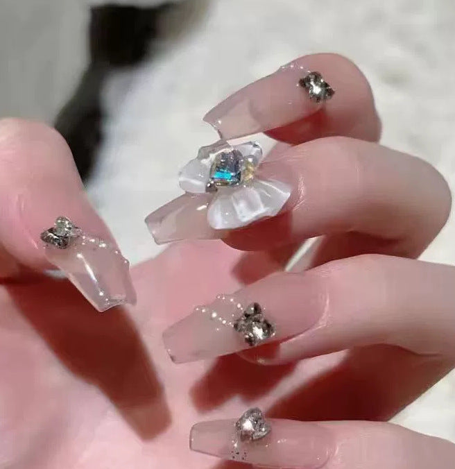 Elegant nail design with pearl embellishment Stornfield