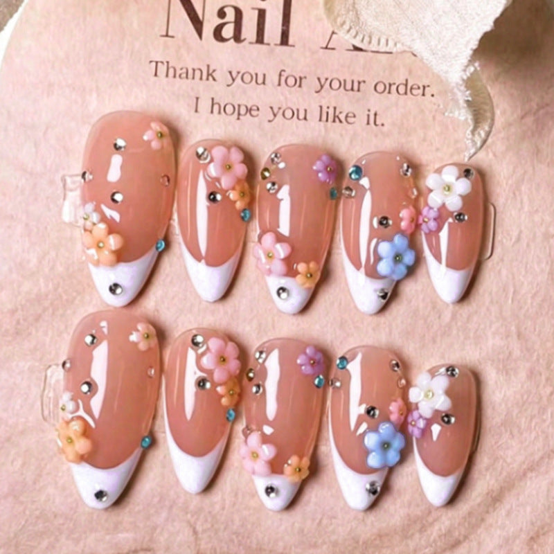 Artificial nail set with delicate floral decorations and sparkling rhinestones Stornfield