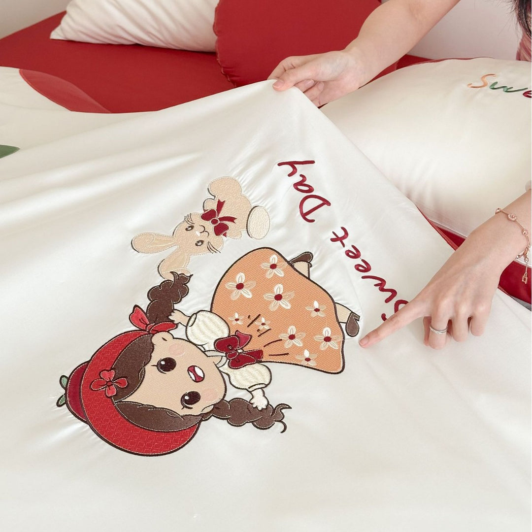 Bedding set with embroidered doll and apple motifs