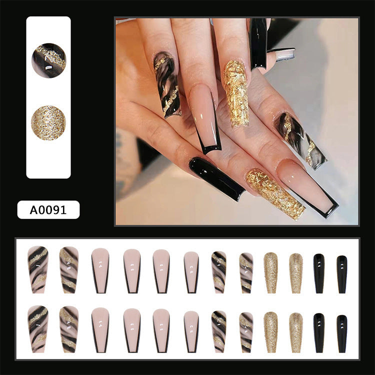 Acrylic nail set with luxurious golden accents and elegant designs Stornfield