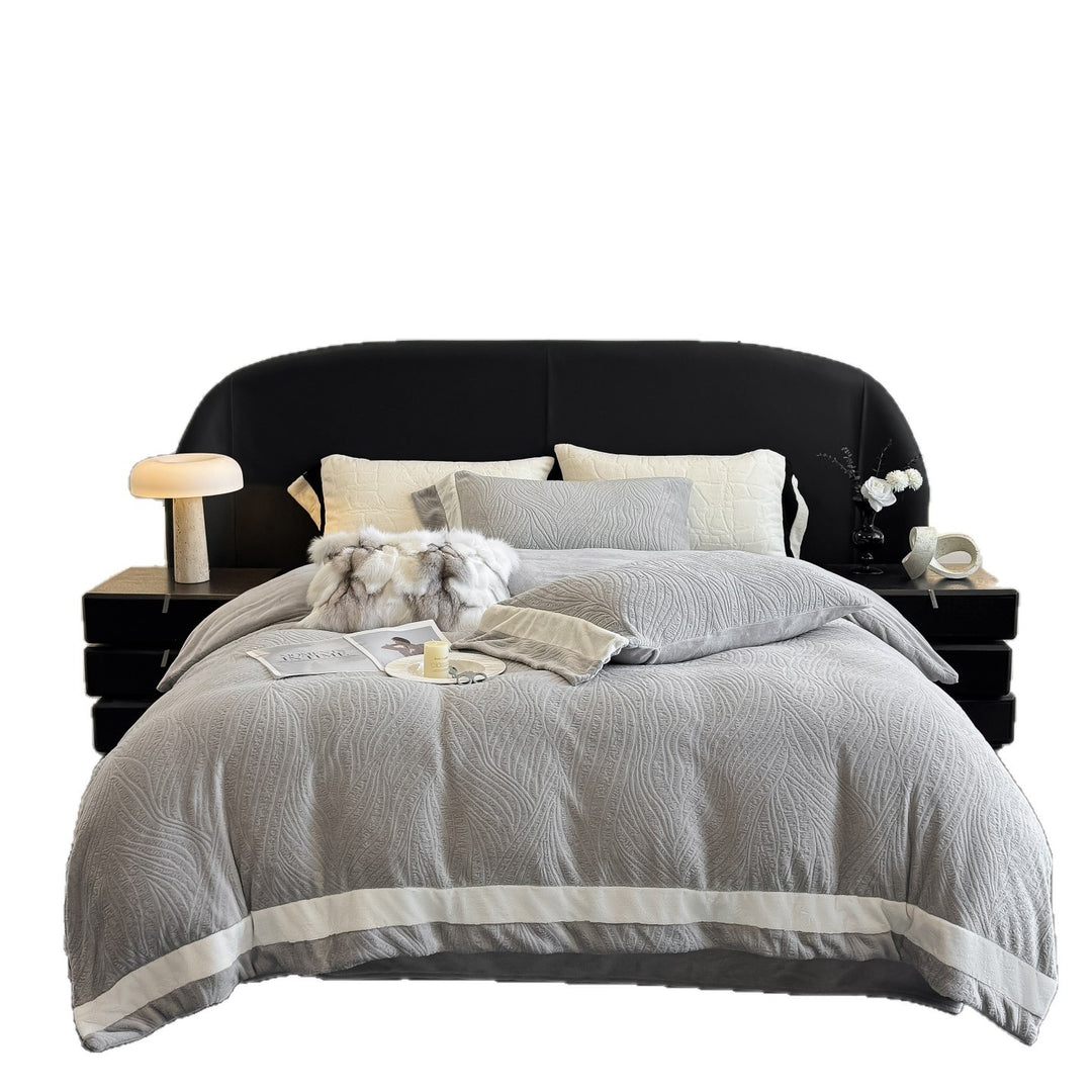 Quilted bedding set made of cotton blend with raised leaf texture and contrasting border