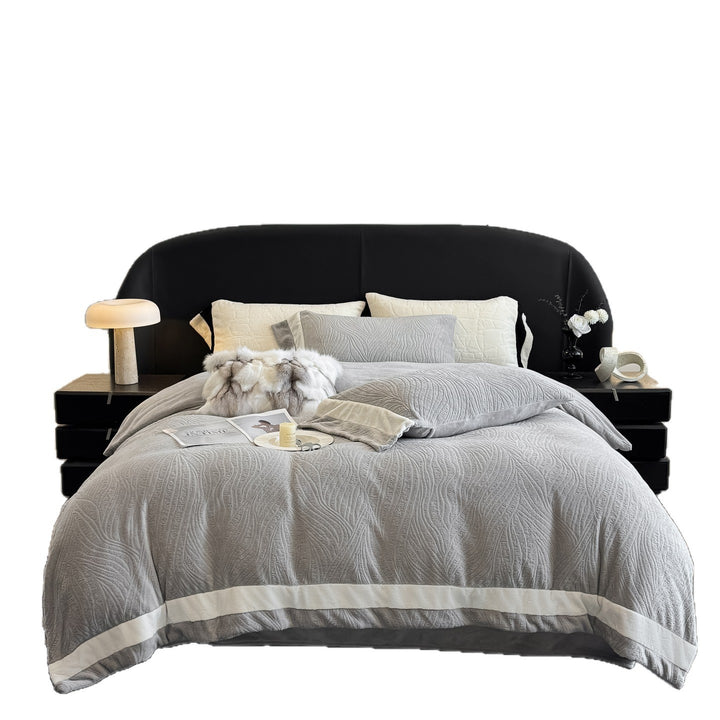 Quilted bedding set made of cotton blend with raised leaf texture and contrasting border