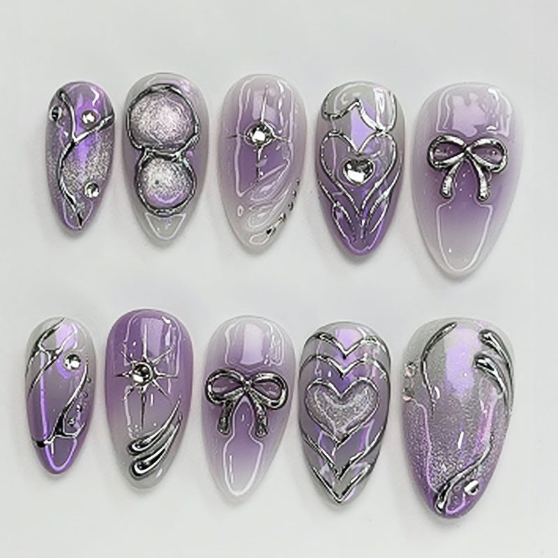 Acrylic nail set with elegant ombre design and delicate embellishments Stornfield