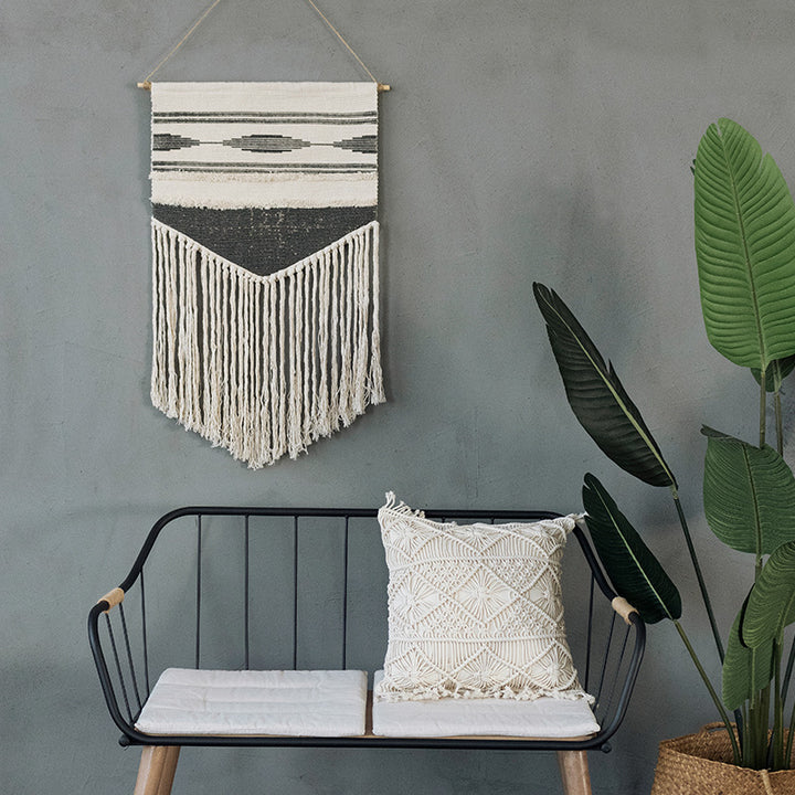 Woven wall hanging in Aztec style with cotton fringes and wooden rod