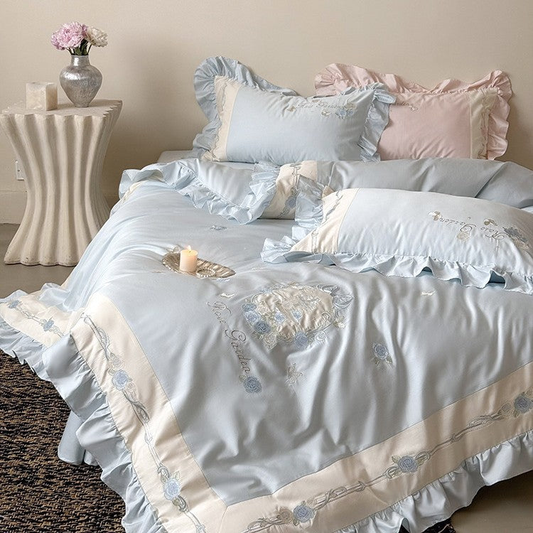 Delicate embroidered cotton satin bedding set with ruffle, satin trim, and rose motif