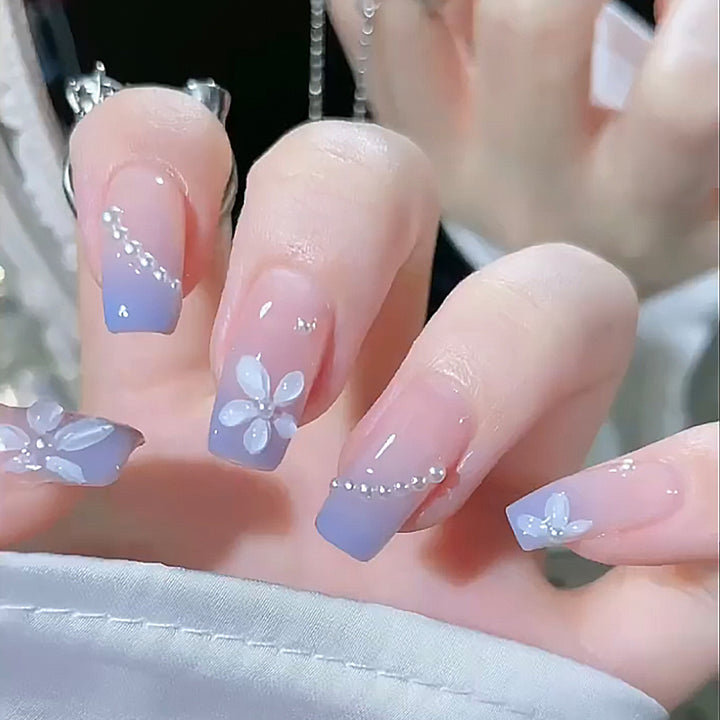 Nail set with elegant floral accents and glitter embellishments Stornfield