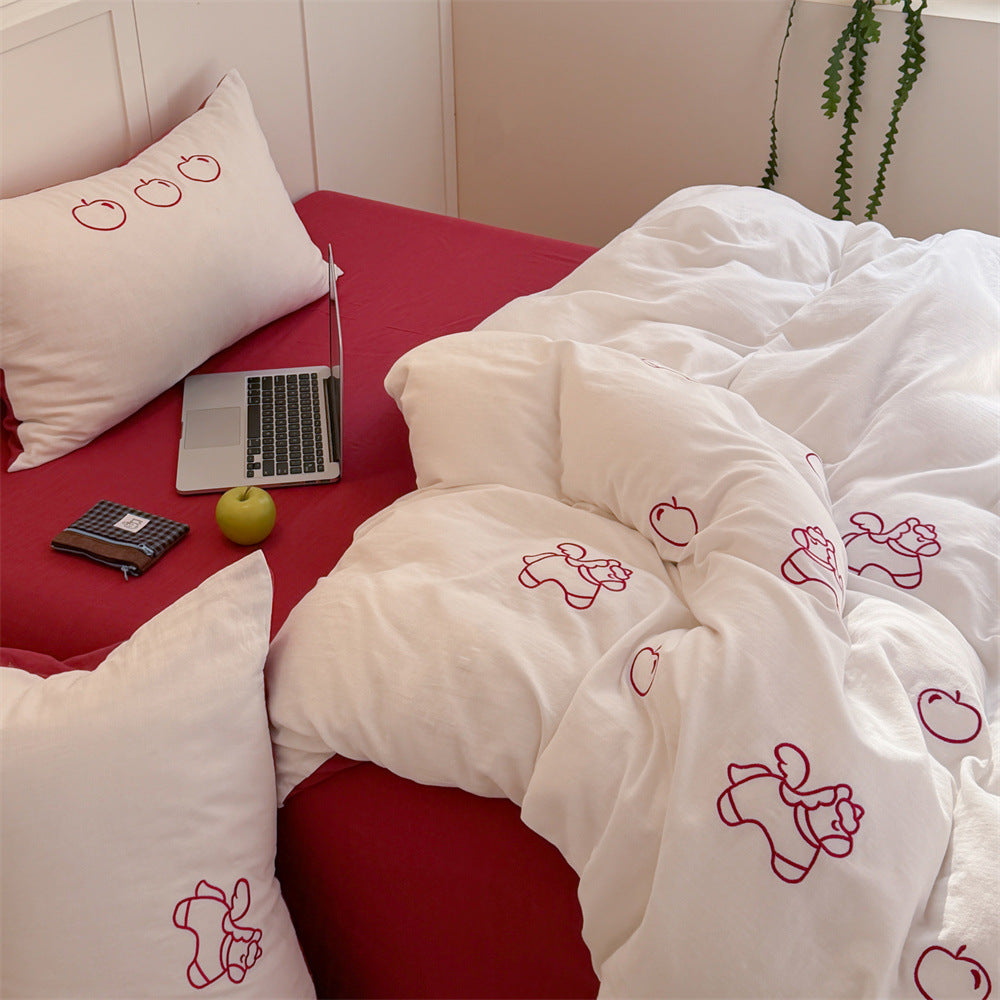 Quilted comforter with delicate bird and cloud embroidery