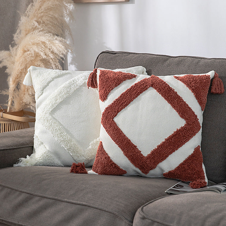 Square decorative cushion cover made of cotton bouclé with raised diamond pattern and corner tassels