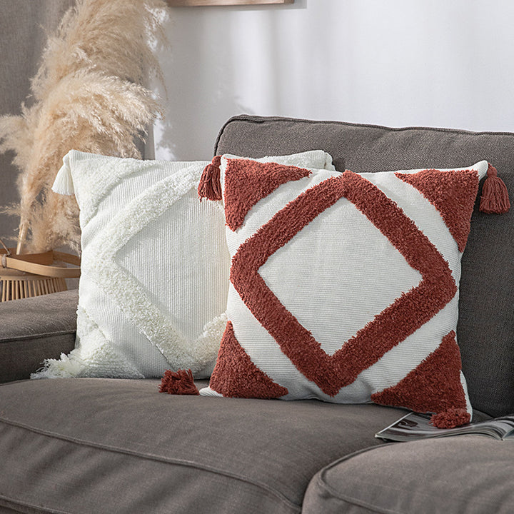 Square decorative cushion cover made of cotton bouclé with raised diamond pattern and corner tassels