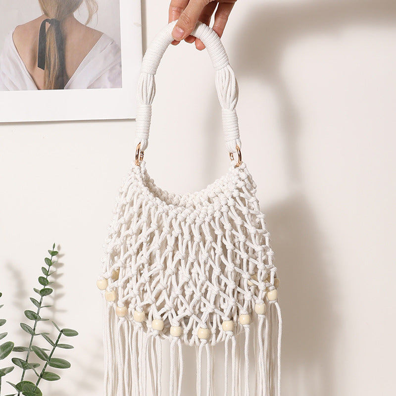 Macrame bag with decorative fringes and wooden beads Stornfield