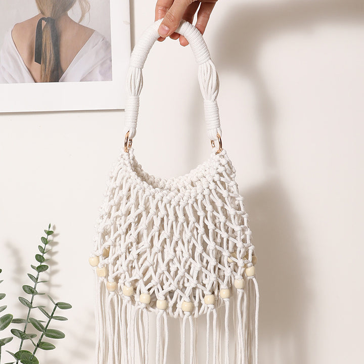 Macrame bag with decorative fringes and wooden beads Stornfield