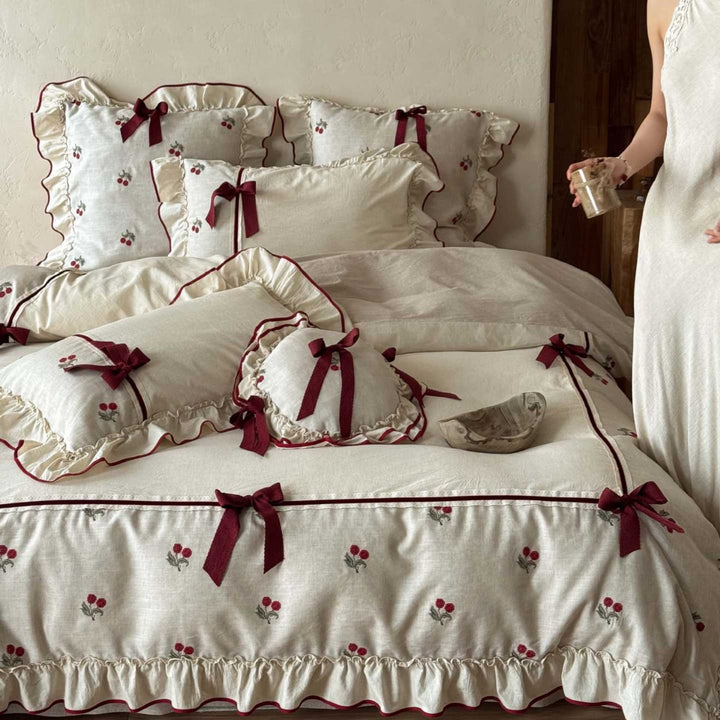 Country house bedding set made of linen-cotton blend with hand-embroidered cherry motifs, ruffles and decorative bows